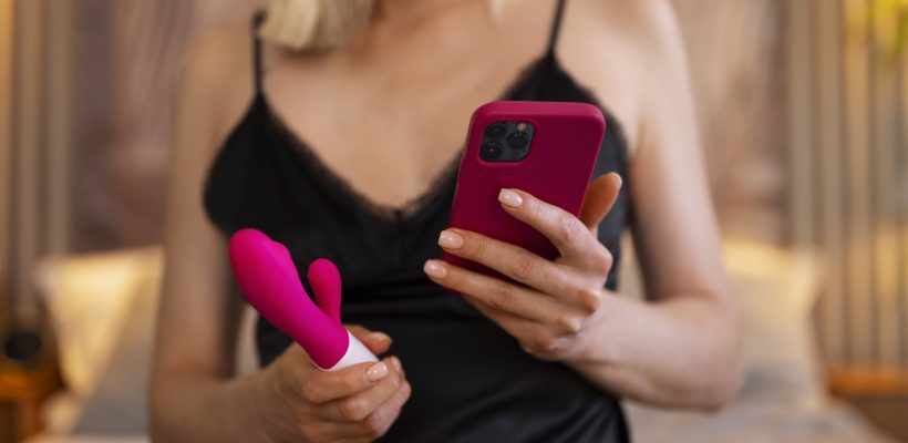 front-view-woman-with-smartphone-vibrator